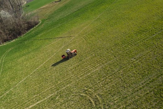 farmer driving uphill crawled tractor in the farm during spring season
