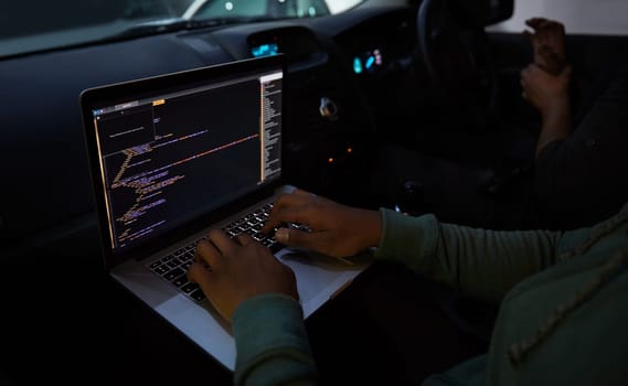 Hacker, code and laptop with person in car for ransomware, cyber security and phishing. Coding, technology and crime with hands of programmer typing for fraud, network system and data scam at night.