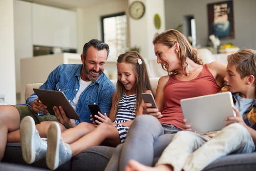 Technology, streaming and a happy family on the sofa for internet, social media and communication. Smile, bonding and a mother, father and children with a tablet and phone for online games at home.