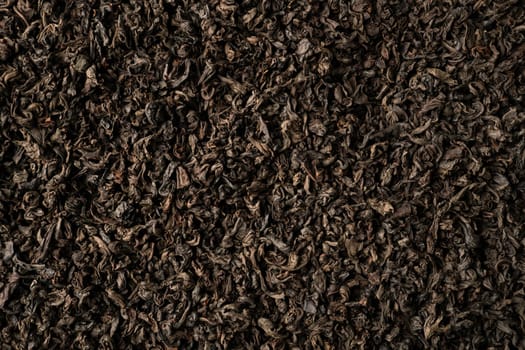 Background of black fanning or broken loose leaf tea. Close up, top view