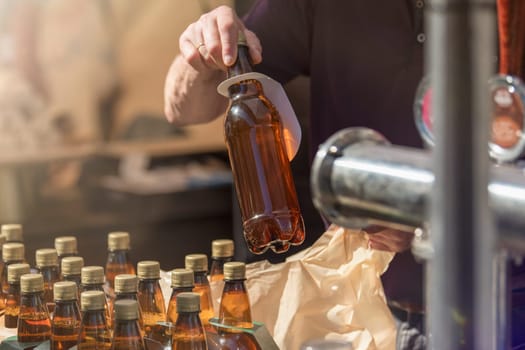 Craft beer vendor packaging beer bottles for a customer. The concept of a small business for the production of beer. Copy space