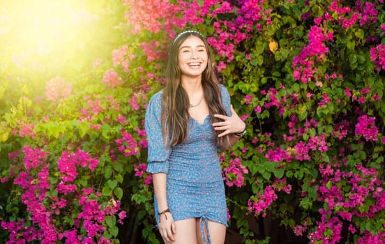 Portrait of beautiful latin girl smiling in a flower garden. happy young latin woman smiling in the garden