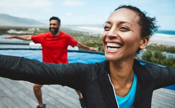 Fitness, wellness and couple doing outdoor yoga stretching together on a rooftop of a building. Happy, smile and young man and woman doing a pilates warm up exercise or workout for health in nature