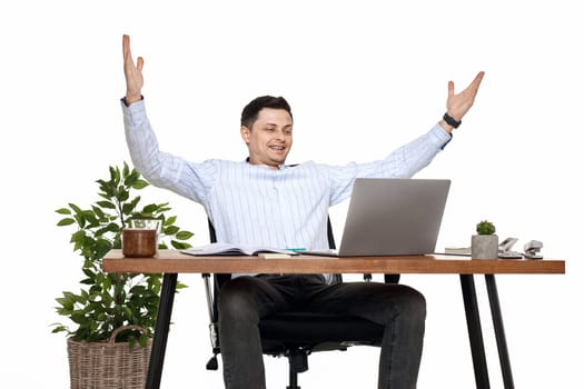 Satisfied businessman gesturing emotionally and celebrating victory in the office
