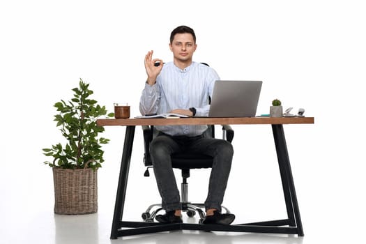 businessman in blue shirt working on laptop pc computer and showing Ok gesture