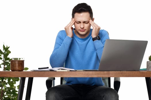sad man have a headache, using laptop in office