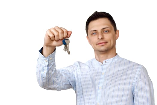 happy caucasian man holding keys on white background. focus on key