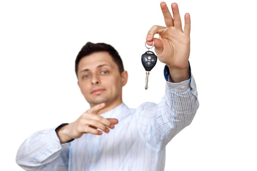 Successful caucasian businessman holding car keys on white background. Car dealerships. focus on key