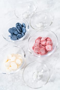 Preparing homemade chocolates. Color chocolate melts in glass pinch bowls.