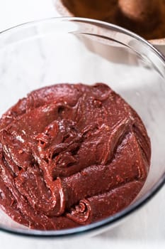 Filling metal bundt cake pan with cake butter to bake red velvet bundt cake with cream cheese glaze