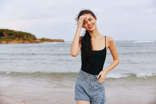 vacation woman sand walking water sea freedom outdoor smiling sunset nature sunlight smile ocean copy lifestyle dress copy-space beach space summer peaceful