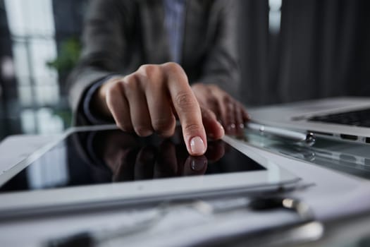 businessman pressing his finger on the screen of the digital tab