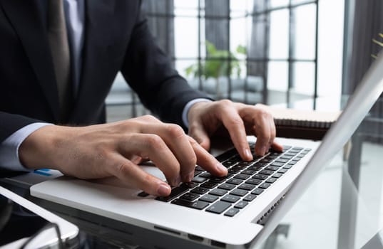 Close-up of male hands typing laptop keyboard. man using laptop