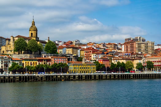 View of Portugalete town by Nervion river, and Sandra Maria basilica, Basque Country, Spain