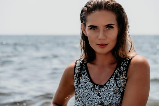 Woman travel sea. Young Happy woman in a long red dress posing on a beach near the sea on background of volcanic rocks, like in Iceland, sharing travel adventure journey