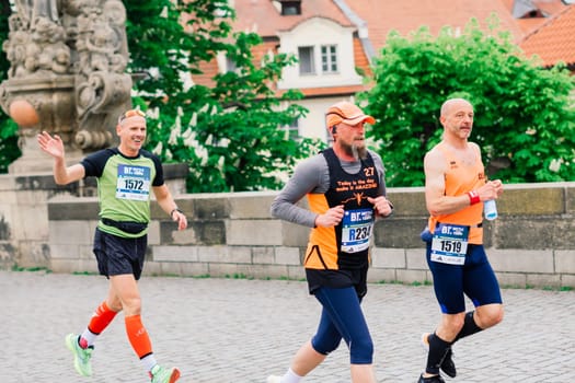 Prague, Czechia - 7th May 2023 - Group athletes runners run marathon in a sunlight