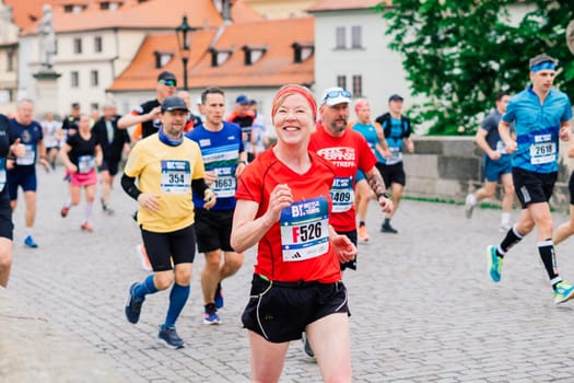 Prague, Czechia - 7th May 2023 - Group athletes runners run marathon in a sunlight