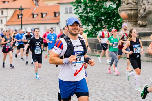 Prague, Czechia - 7th May 2023 - Group athletes runners run marathon in a sunlight