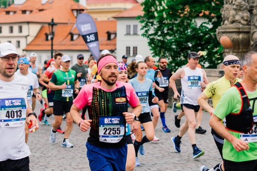 Prague, Czechia - 7th May 2023 - Group athletes runners run marathon in a sunlight