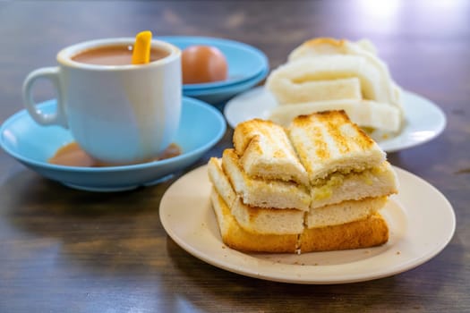 Traditional breakfast set and coffee, boiled eggs and toast, popular in Singapore and Malaysia