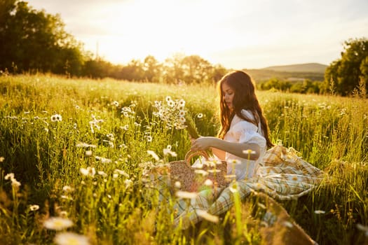 a beautiful woman in a light dress sits in a field of daisies at sunset holding a hat in her hands. High quality photo