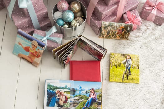 a photo album near the Christmas tree as a gift