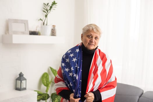 Charming mature woman in USA flag celebrating 4th of july. United States independency day