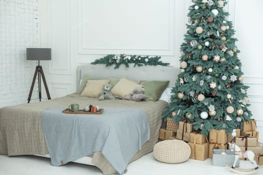 new year cozy home interior with christmas tree and garlands.