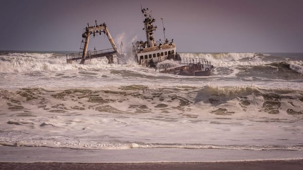 A shipwreck stranded on the beach in the Atlantic Ocean in the Skeleton Coast National Park in Namibia, Africa.