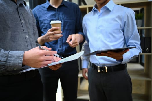 Cropped image of businesspeople discussing startup project, sharing business ideas during coffee break.