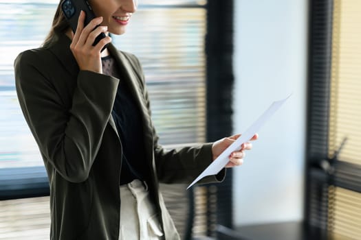 Millennial female corporate CEO having phone conversation, negotiating with her business partner.