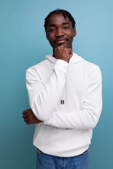 positive young african guy in white sweatshirt.