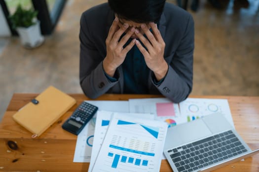 Portrait of business owner, man using computer and financial statements Anxious expression on expanding the market to increase the ability to invest in business