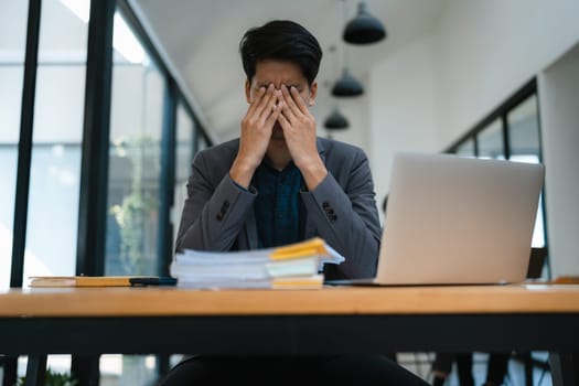 Portrait of business owner, man using computer and financial statements Anxious expression on expanding the market to increase the ability to invest in business