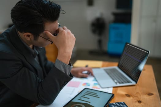 Portrait of business owner, man using computer and financial statements Anxious expression on expanding the market to increase the ability to invest in business