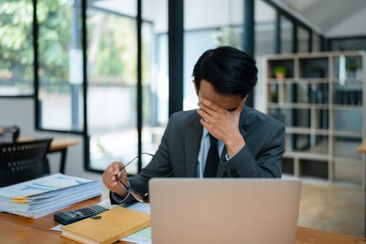 Portrait of business owner, man using computer and financial statements Anxious expression on expanding the market to increase the ability to invest in business