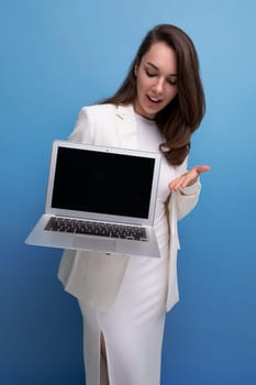 Confident brunette business woman demonstrates laptop screen mockup.