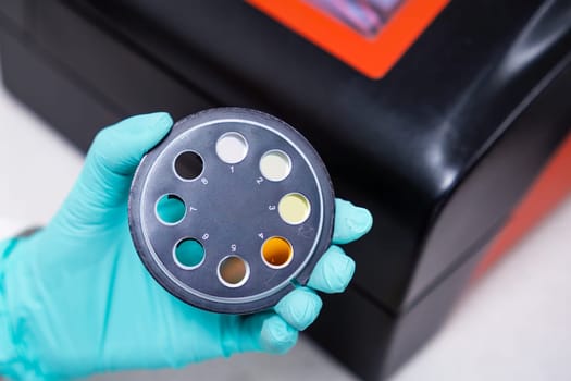 Scientist is holding UV filters for spectrophotometer for chemical analysis.