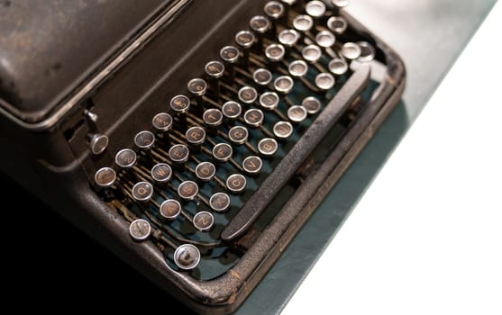 Antique iron typewriter with the classic alphabet keys, a piece of old technology from another era.