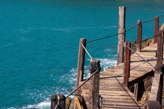 The wooden bridge at cliff and sea