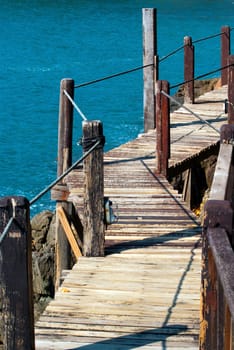 The wooden bridge at cliff and sea