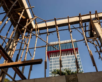 Temporary wooden pole for supports the concrete structure a building under construction