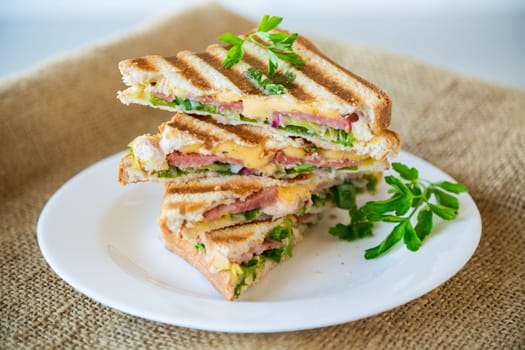 fried toasts stuffed with sausage, cheese and greens inside, in a bowl on the table..