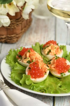 Stuffed eggs with salmon caviar are a popular appetizer for any occasion. Elegantly decorated and expertly seasoned, they will always be a beautiful appetizer at a party.