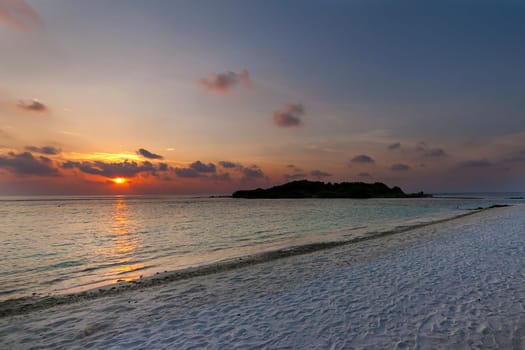 Colorful sunset on an island in the Maldives in the Indian Ocean