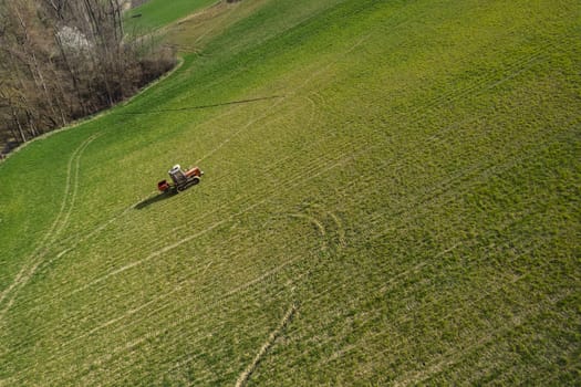 farmer driving uphill crawled tractor in the farm during spring season