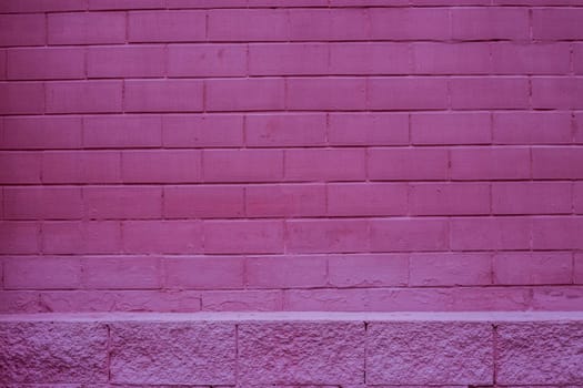 The brick wall of the building is painted red.