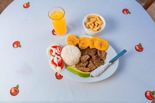 Tradicional lunch served at the table. Top view of traditional lunch with orange juice on the table.