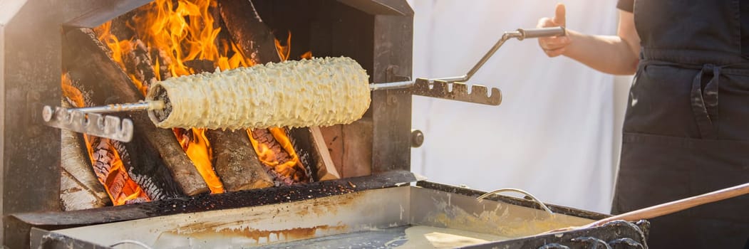 Baumkuchen baking. Making a puff traditional Lithuanian pie in the oven - Shakotis or Spruce pie. High quality photo