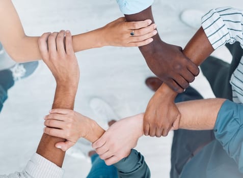 Wrist hands, team building and business people support diversity, group and collaboration, cooperation and community mission. Above solidarity, partnership and motivation of goals, trust and teamwork.